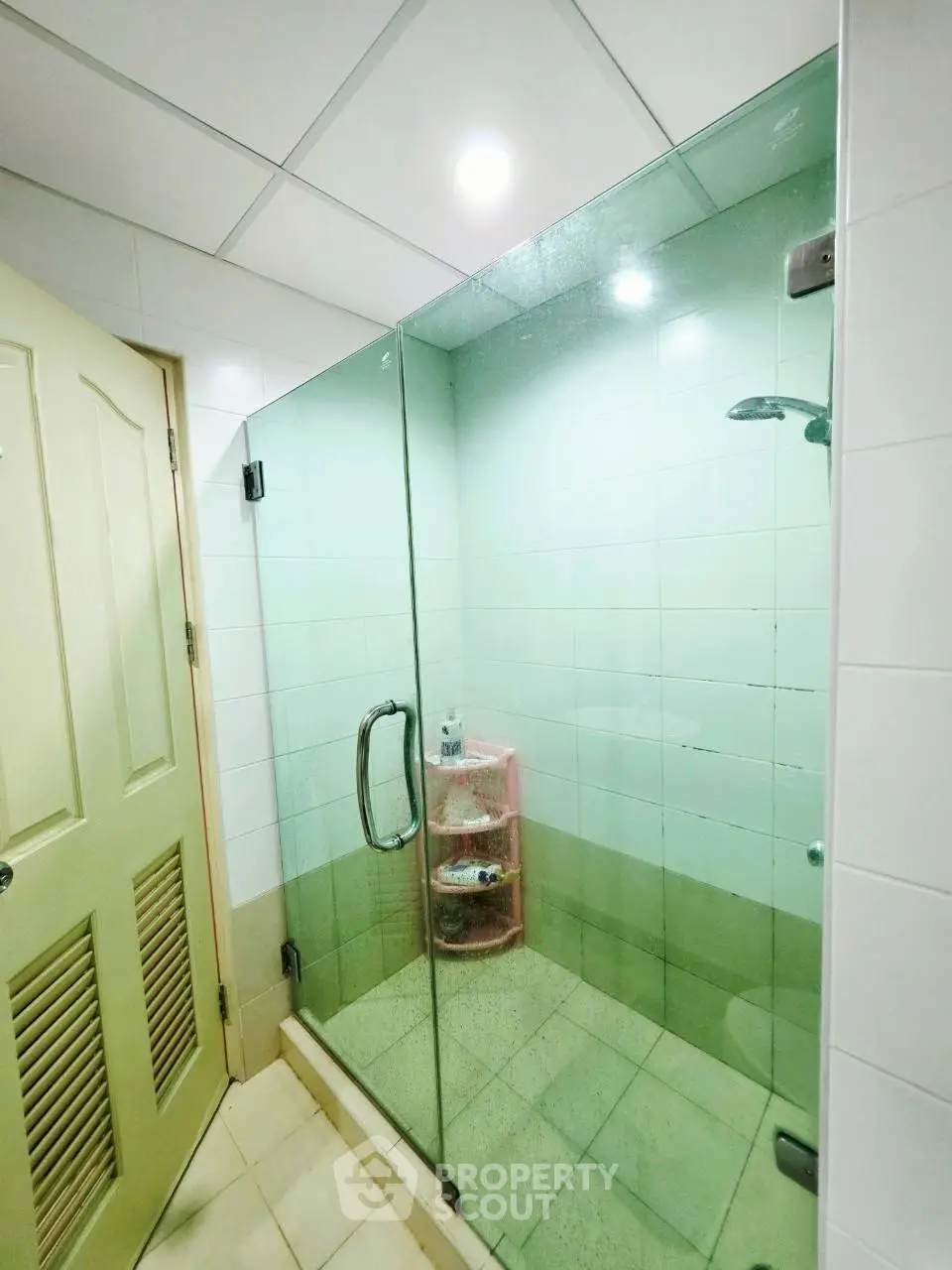 Modern bathroom with glass shower enclosure and tiled walls