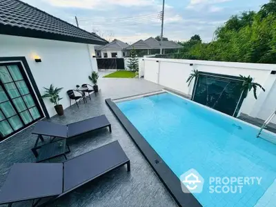 Luxurious modern home with private pool and stylish outdoor seating area.