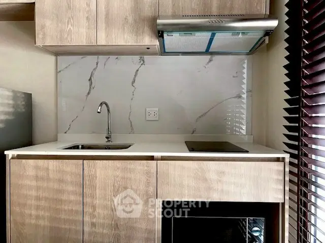 Modern kitchen with sleek cabinetry and marble backsplash