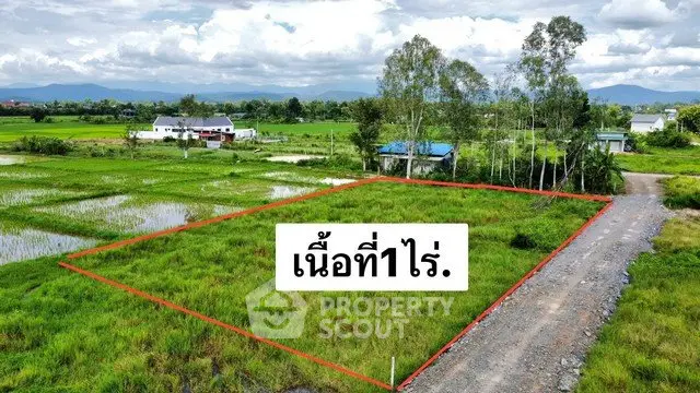 Scenic land plot for sale with lush greenery and mountain views, ideal for development.