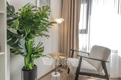 Stylish modern living room corner with cozy chair and lush indoor plant