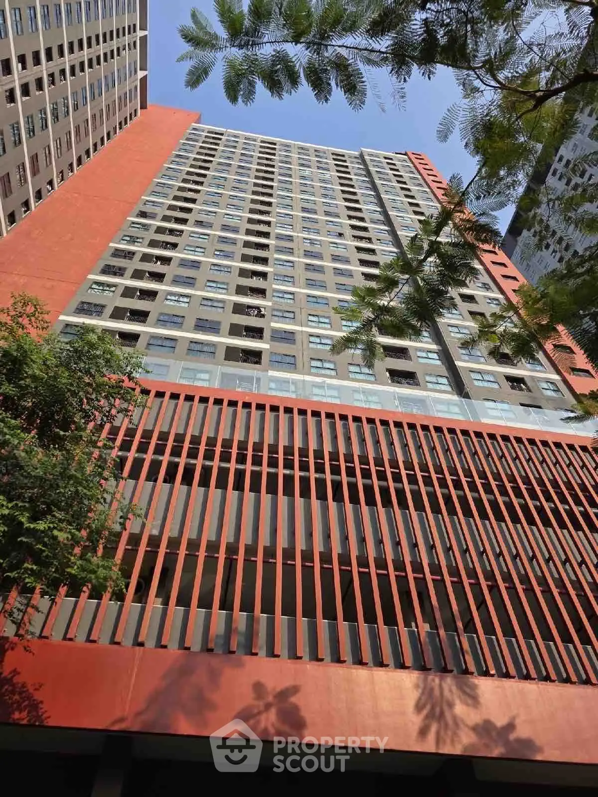 Stunning high-rise building with modern architectural design and vibrant red facade.