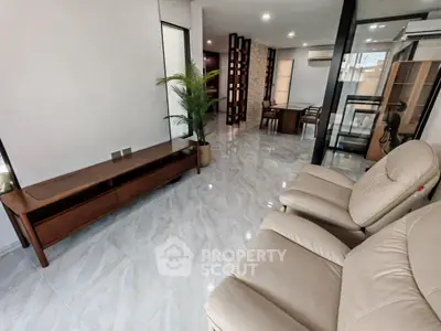 Spacious modern living room with elegant furniture and marble flooring