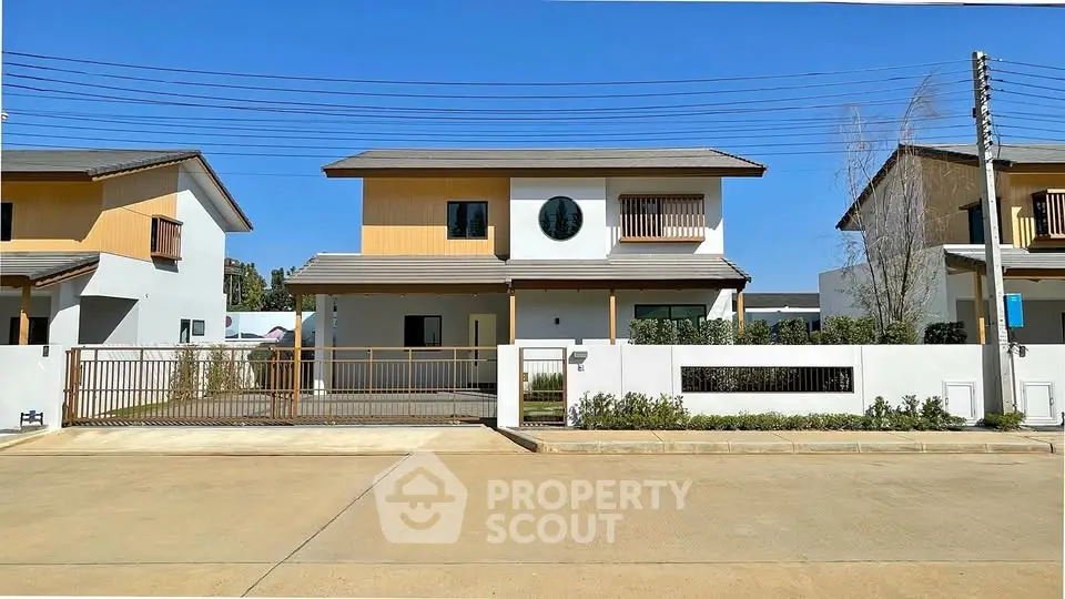 Modern two-story house with a spacious driveway and contemporary design in a suburban neighborhood.
