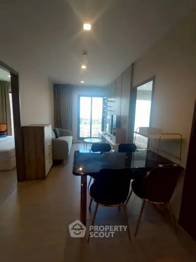 Modern apartment interior with open layout and stylish furniture, featuring a cozy living area and dining space.