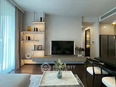 Modern living room with sleek furniture and large TV, perfect for stylish urban living.