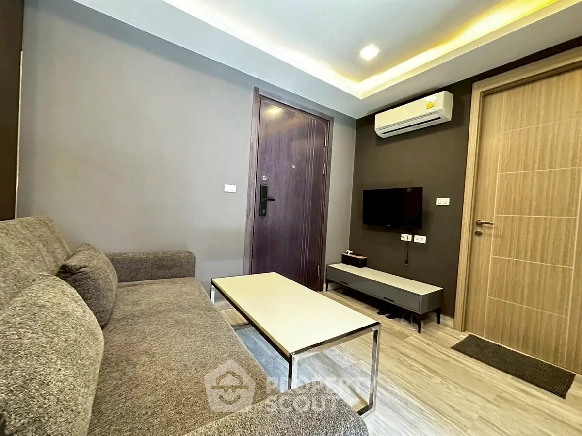 Modern living room with sleek furniture and air conditioning unit