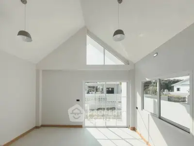 Bright and airy modern living room with high ceilings and large windows