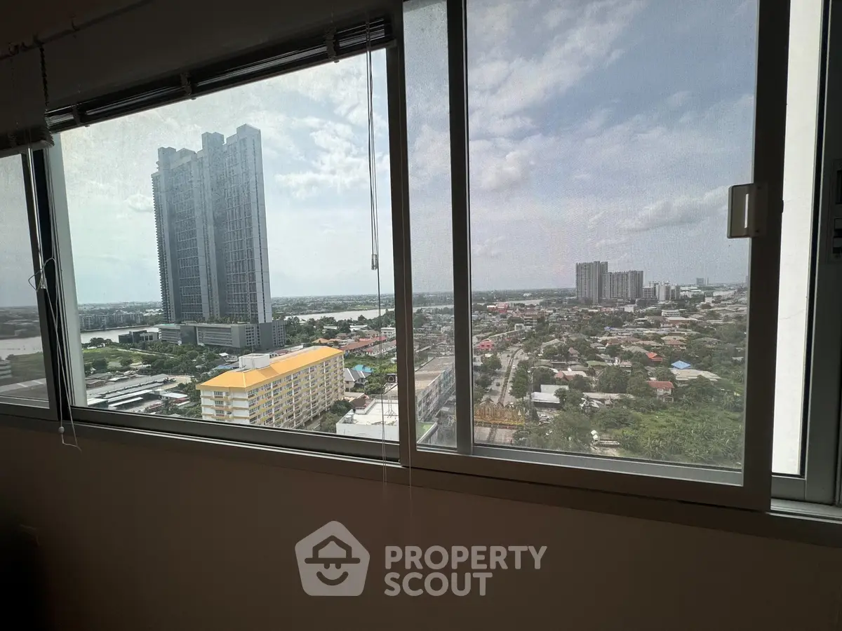 Stunning cityscape view from high-rise apartment window, showcasing urban skyline and expansive horizon.