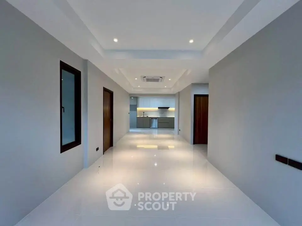 Spacious modern interior with sleek kitchen and recessed lighting, perfect for contemporary living.