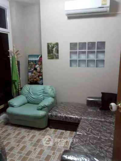 Cozy living room with modern decor and air conditioning, perfect for relaxation.