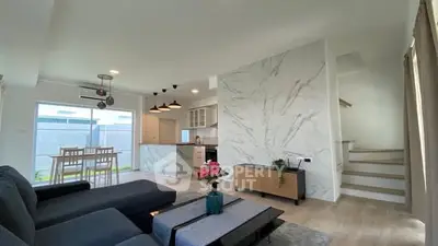 Modern open-plan living room with stylish decor and natural light