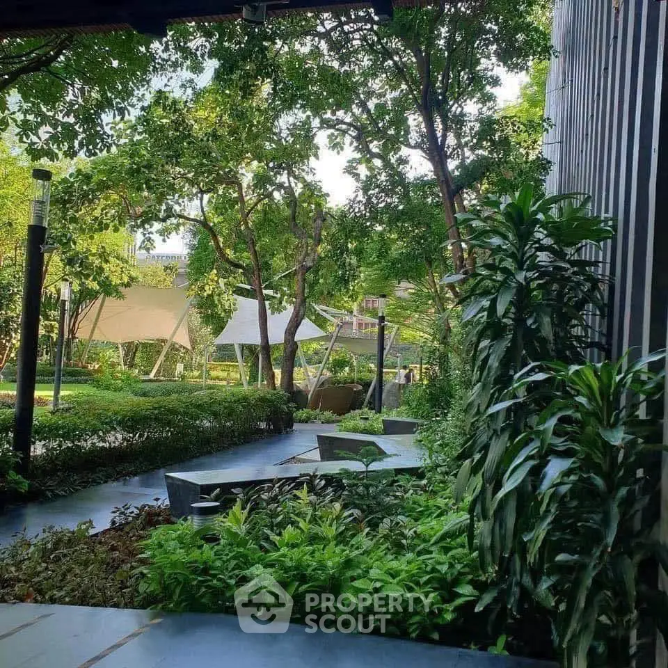 Lush garden view with modern landscaping and shaded seating area in upscale property.