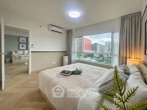 Spacious bedroom with city view and modern decor