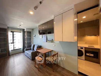 Modern living room with open kitchen and stylish furniture in a high-rise apartment