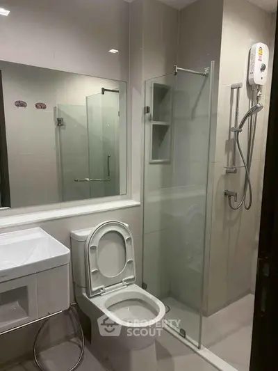 Modern bathroom with glass shower enclosure and sleek fixtures