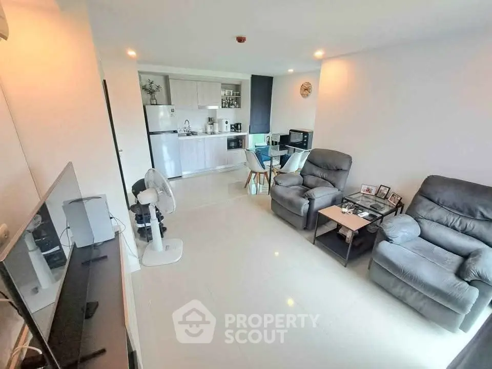 Modern living room with open kitchen and cozy seating area