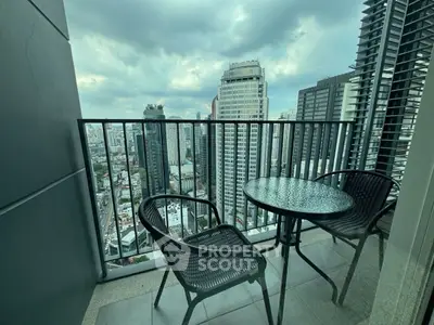 Stunning city view from a high-rise balcony with modern outdoor seating.