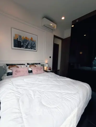 Modern bedroom with stylish decor and cozy ambiance, featuring a comfortable bed and chic artwork.