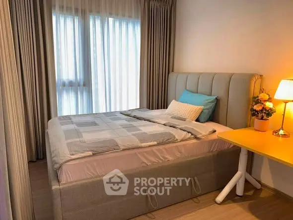 Cozy bedroom with stylish bed and soft lighting, perfect for relaxation.