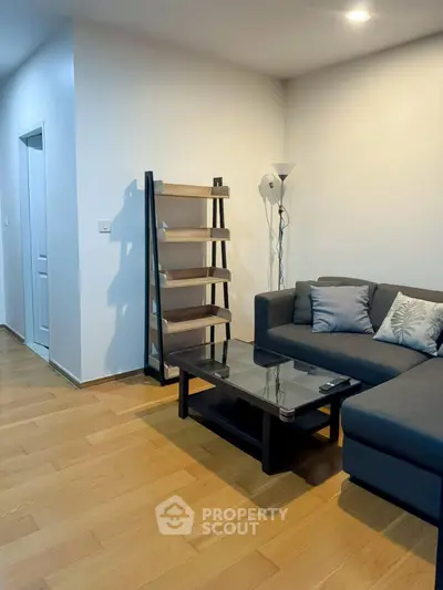 Modern living room with sleek furniture and wooden flooring, perfect for cozy gatherings.