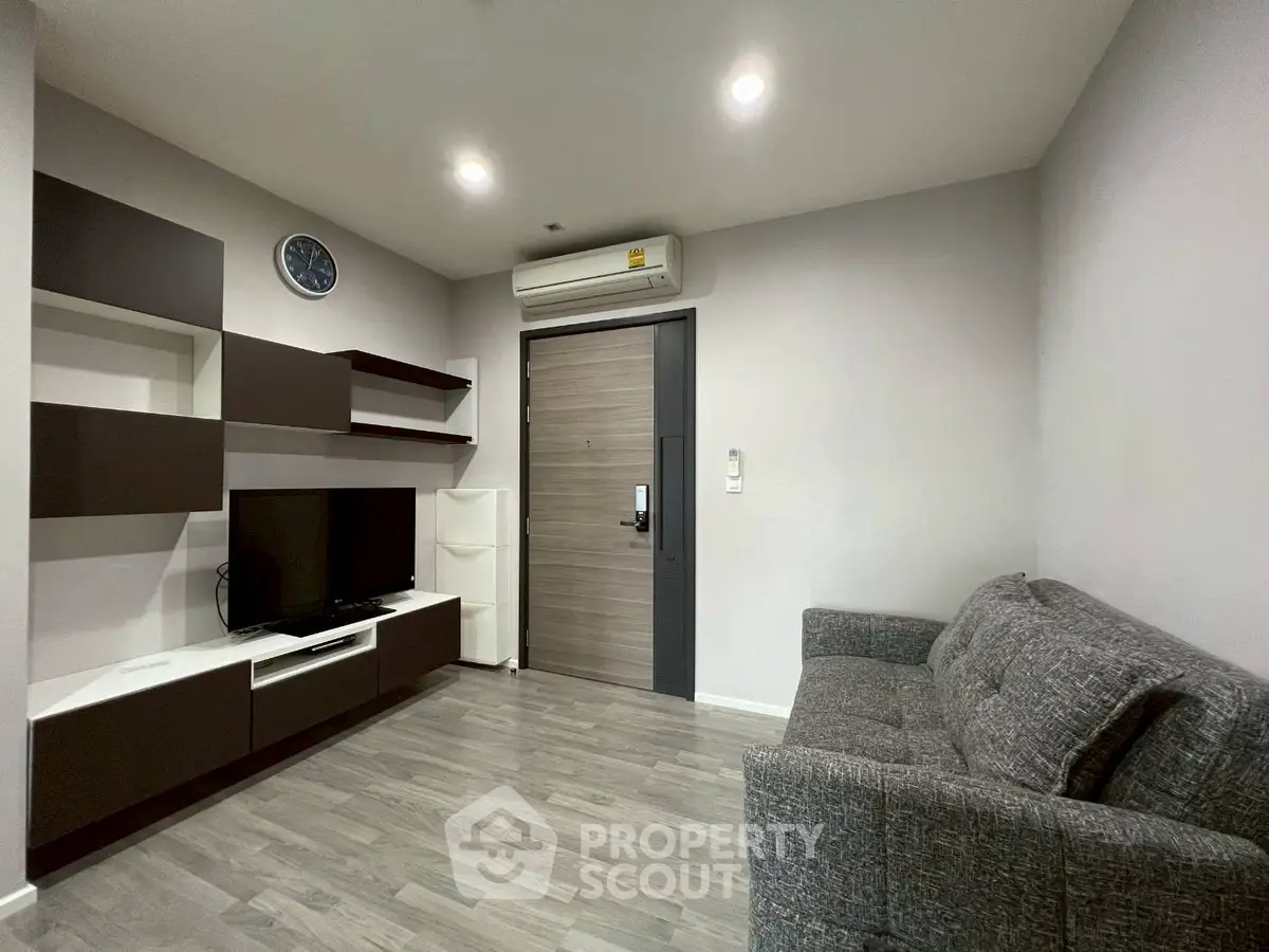 Modern living room with sleek furniture and wall-mounted TV