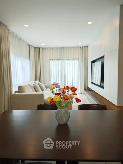 Elegant living room with modern decor and large windows for natural light.