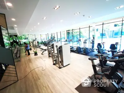 Spacious modern gym with large windows and natural light