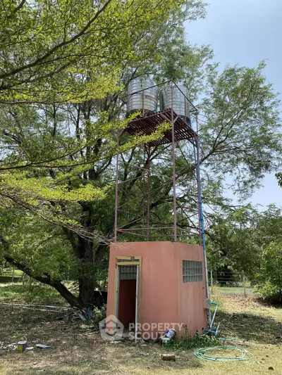 Unique water tower structure in lush green garden setting