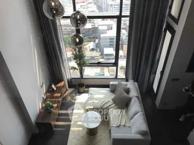 Stunning high-rise living room with floor-to-ceiling windows and city view, featuring modern decor and cozy seating.