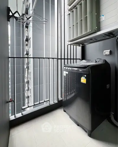 Modern apartment balcony with washing machine and sleek design.