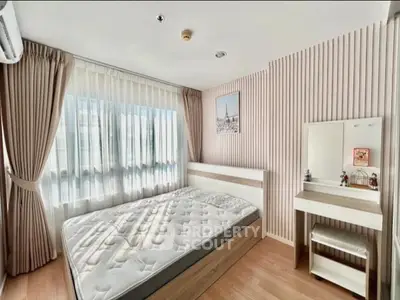 Bright and airy bedroom with large window and stylish decor