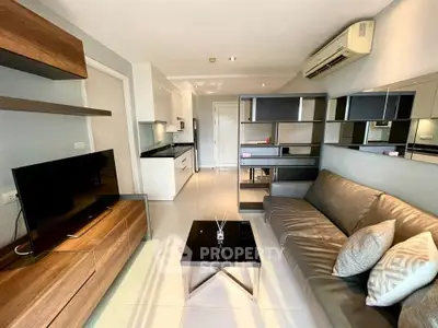 Modern living room with sleek furniture and open kitchen layout in a stylish apartment.