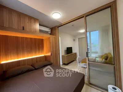 Modern bedroom with sliding glass door and built-in wooden storage