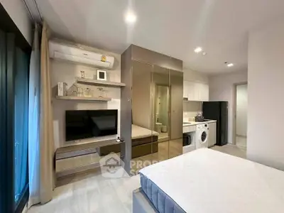 Modern studio apartment with sleek design, featuring a mirrored wardrobe, wall-mounted TV, and in-unit washing machine.