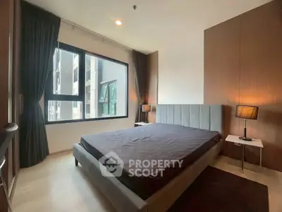 Modern bedroom with large window and stylish decor in urban apartment