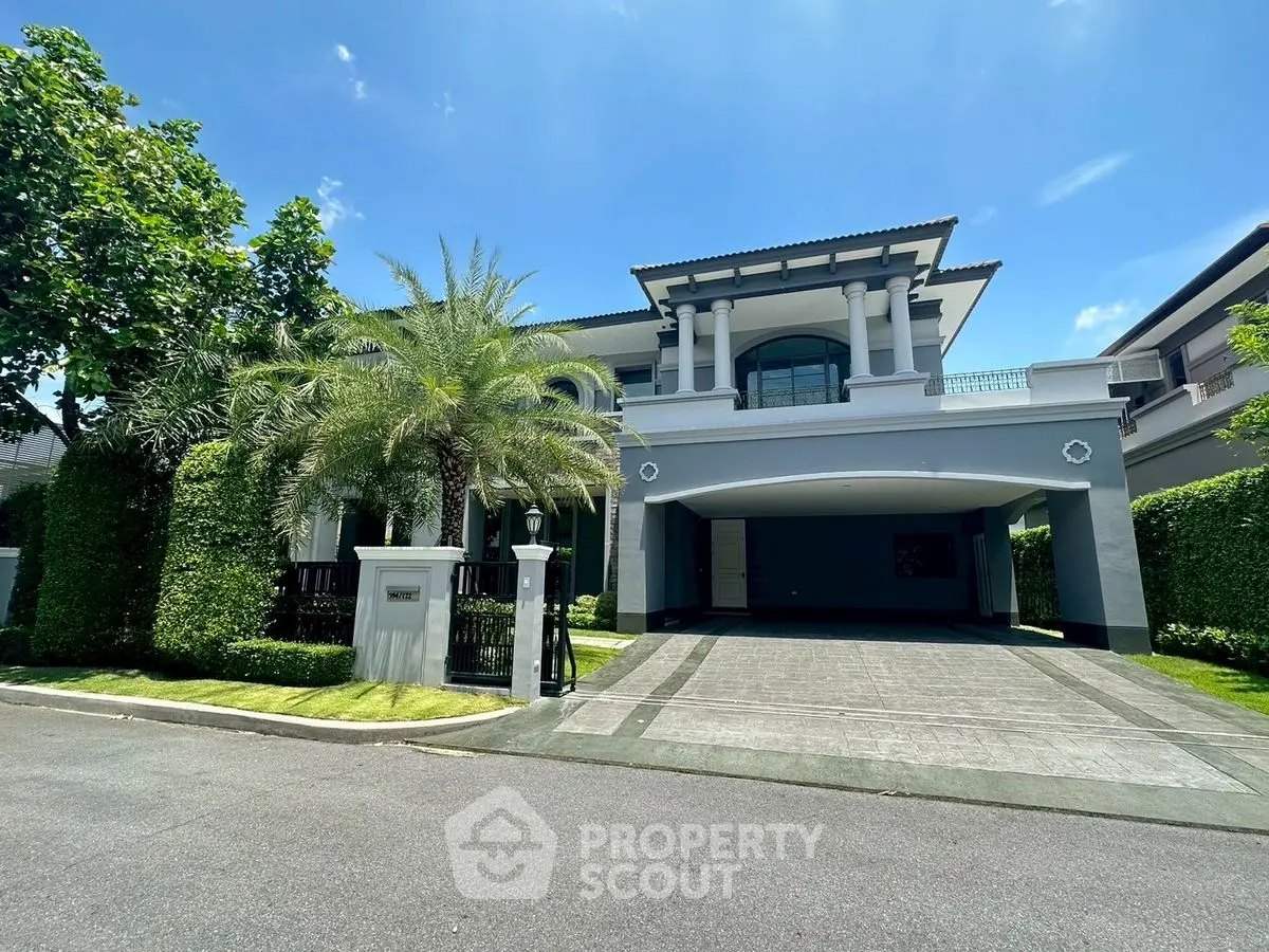 Luxurious modern villa with grand entrance and lush greenery, perfect for upscale living.