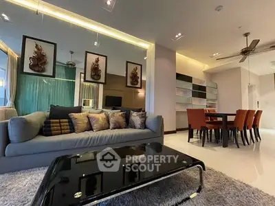 Luxurious living room with modern decor and dining area in open layout apartment.