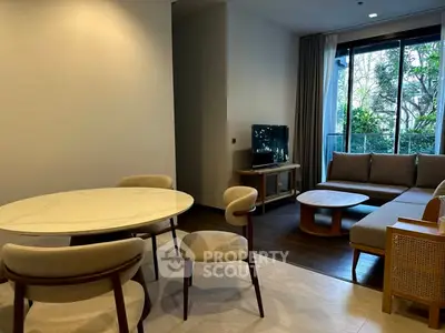 Modern living room with elegant furniture and large window view.