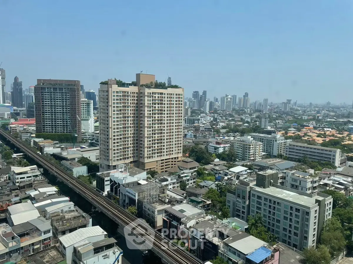 Stunning cityscape view from high-rise building showcasing urban skyline and residential architecture.