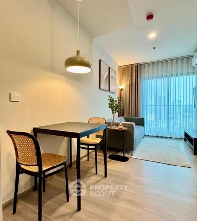 Modern living room with dining area, stylish decor, and natural light