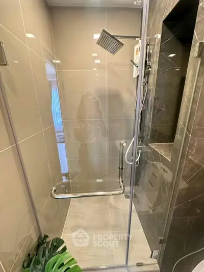Modern bathroom with sleek glass shower enclosure and stylish fixtures
