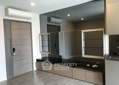 Modern living room with sleek mirrored wall and stylish storage unit