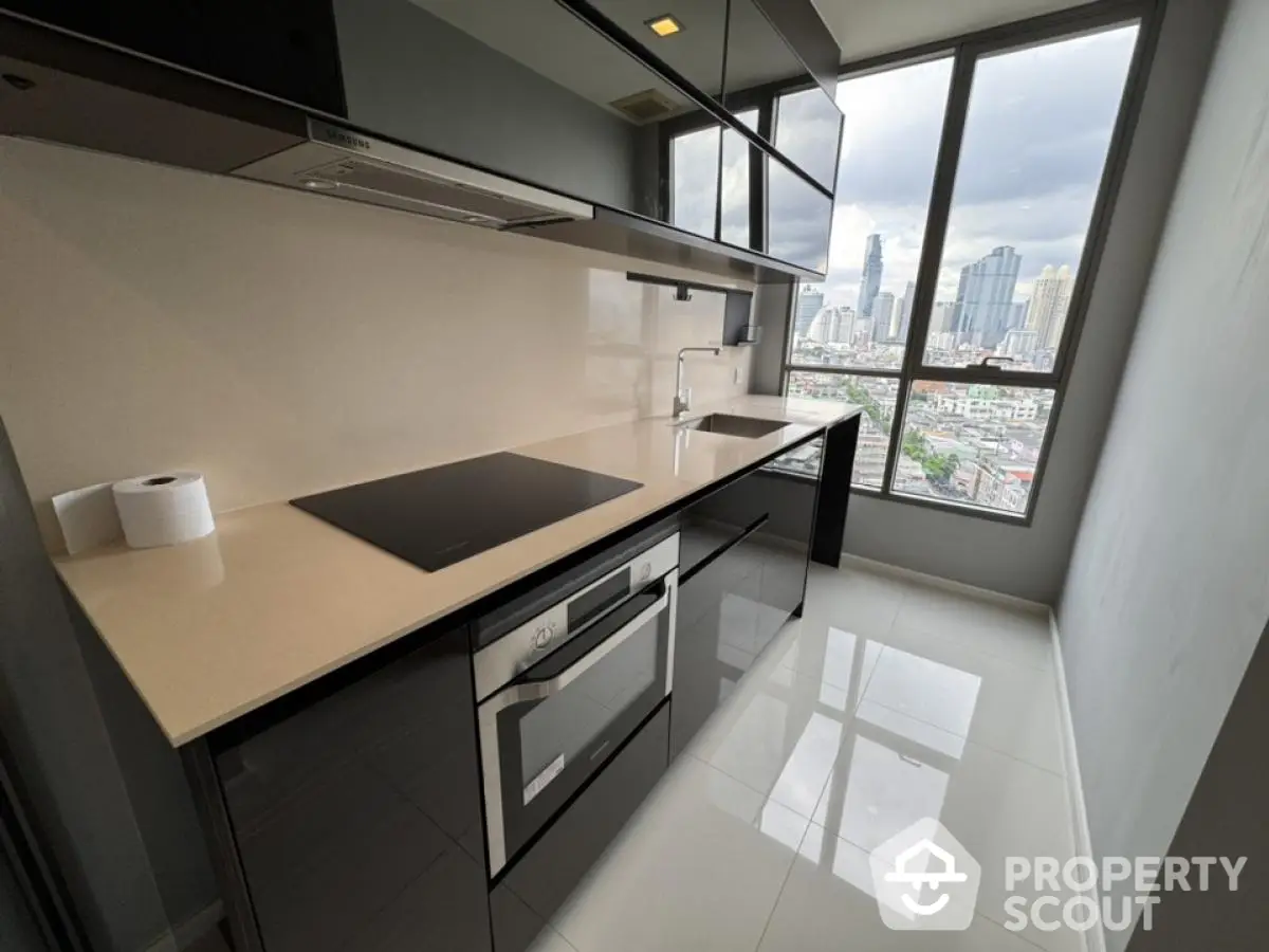 Modern kitchen with sleek black cabinets and city view from large window