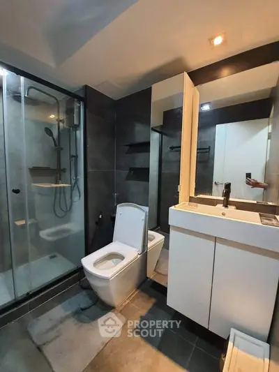 Modern bathroom with sleek design, glass shower, and contemporary fixtures.