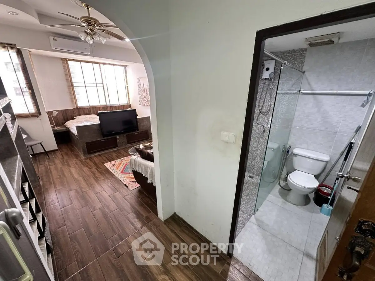 Cozy studio apartment with wooden flooring and modern bathroom