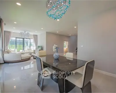Elegant dining area with modern chandelier and open layout in luxury home