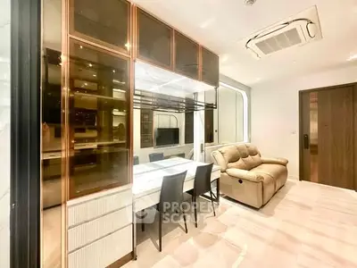 Modern living room with sleek furniture and built-in storage, featuring a cozy sofa and dining area.