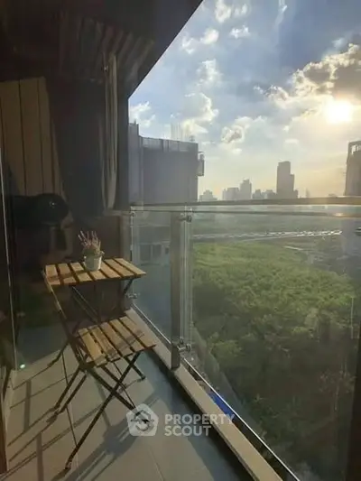 Charming balcony with stunning city view and cozy seating area, perfect for relaxation.