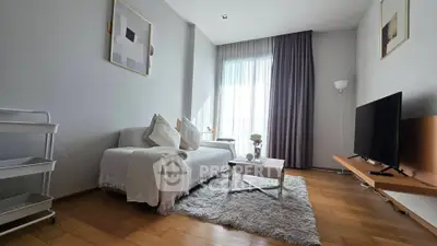 Modern living room with cozy sofa, stylish decor, and natural light.